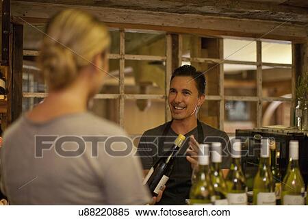Sommelier selecting bottle of wine in wine shop View Large Photo Image Stock Photography - Sommelier selecting bottle of wine in wine shop. Fotosearch