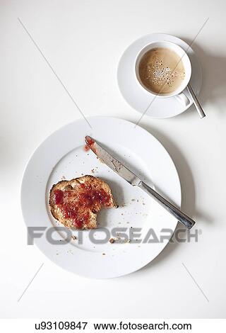 Stock Photo - Still life of breakfast with bread and jam, and a cup of coffee. Fotosearch