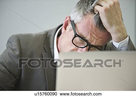 Stressed mature businessman in office View Large Photo Image Stock Image - Stressed mature businessman in office. Fotosearch
