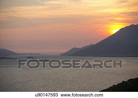Stock Image - Sunset over the mountains and sea, Orebic, Croatia. Fotosearch