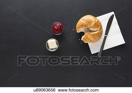Stock Photograph - Sweet roll with jam and butter. Fotosearch