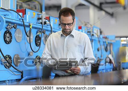 Technical manager checking information on digital tablet View Large Photo Image Stock Image - Technical manager checking information on digital tablet. Fotosearch