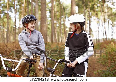 Twin brothers on BMX bikes chatting in forest View Large Photo Image Stock Photo - Twin brothers on BMX bikes chatting in forest. Fotosearch