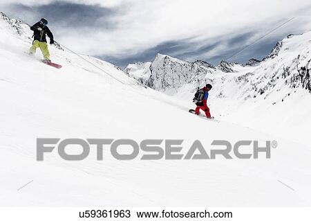 Two men snowboarding downhill, Obergurgl, Austria View Large Photo Image Stock Image - Two men snowboarding downhill, Obergurgl, Austria. Fotosearch