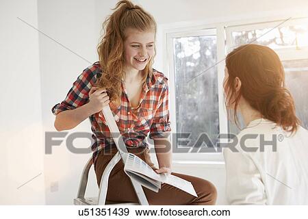 Two teenage sisters discussing color swatches for bedroom View Large Photo Image Stock Photo - Two teenage sisters discussing color swatches for bedroom. Fotosearch