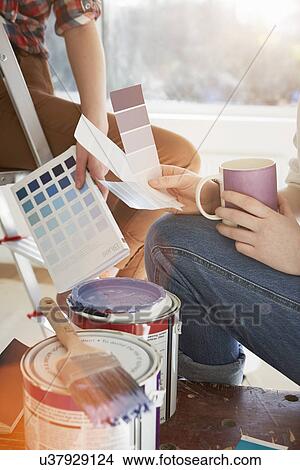 Picture - Two teenage sisters with coffee and color swatches. Fotosearch
