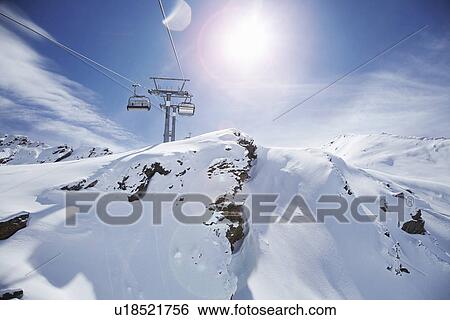 Stock Photograph - View of ski lift and snow covered mountains, Obergurgl, Austria. Fotosearch