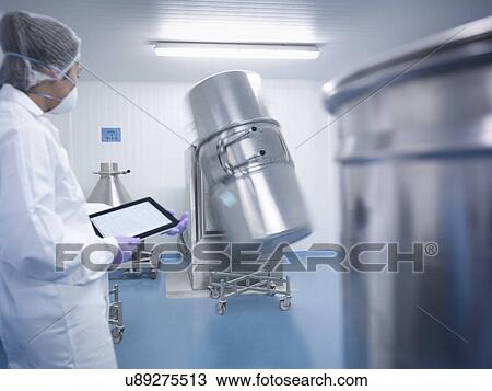 Worker holding digital tablet and watching ingredient mixing machine in pharmaceutical factory View Large Photo Image Stock Image - Worker holding digital tablet and watching ingredient mixing machine in pharmaceutical factory. Fotosearch