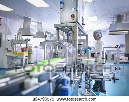 Worker inspecting products on production line in pharmaceutical factory View Large Photo Image Stock Photography - Worker inspecting products on production line in pharmaceutical factory. Fotosearch