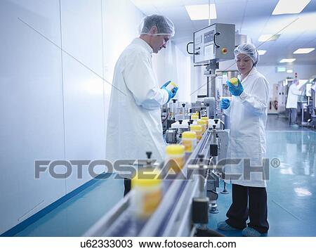 Workers inspecting packaging in pharmaceutical factory View Large Photo Image Stock Image - Workers inspecting packaging in pharmaceutical factory. Fotosearch