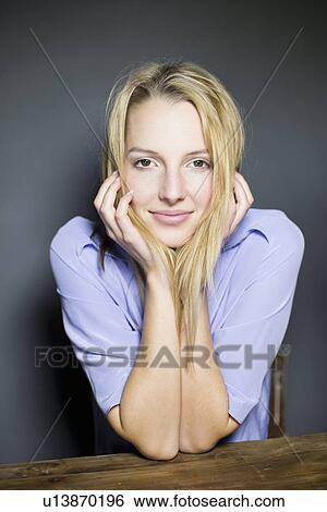 Young blonde woman leaning on elbows View Large Photo Image Stock Photograph - Young blonde woman leaning on elbows. Fotosearch