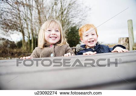 Picture - Young brother and sister playing outdoors. Fotosearch