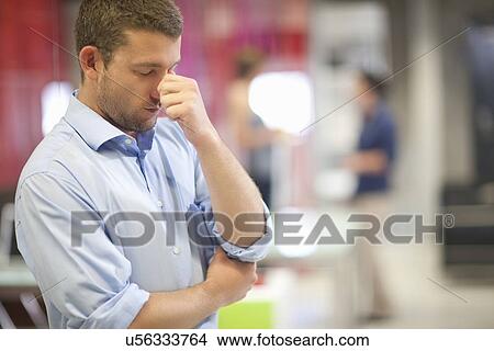 Young businessman looking stressed in office View Large Photo Image Picture - Young businessman looking stressed in office. Fotosearch