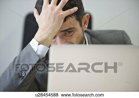 Young businessman looking stressed View Large Photo Image Stock Photo - Young businessman looking stressed. Fotosearch