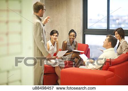 Young businessman presenting ideas to colleagues View Large Photo Image Stock Photo - Young businessman presenting ideas to colleagues. Fotosearch
