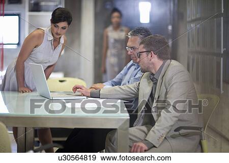 Stock Photo - Young businessman presenting strategy to colleagues. Fotosearch