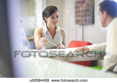 Stock Photo - Young businesswoman meeting client in office. Fotosearch