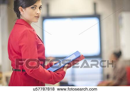 Young businesswoman preparing for meeting in office View Large Photo Image Stock Photo - Young businesswoman preparing for meeting in office. Fotosearch