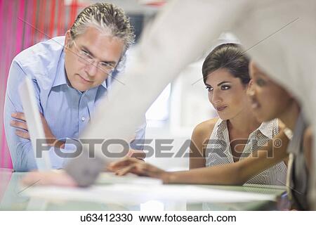 Young businesswoman presenting strategy in meeting View Large Photo Image Stock Image - Young businesswoman presenting strategy in meeting. Fotosearch