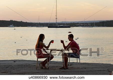 Young couple toasting each other on pier, Loviste, Croatia View Large Photo Image Stock Image - Young couple toasting each other on pier, Loviste, Croatia. Fotosearch
