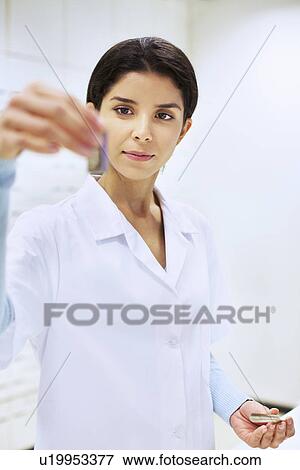 Young female pharmacist checking medicine in pharmacy View Large Photo Image Stock Photo - Young female pharmacist checking medicine in pharmacy. Fotosearch