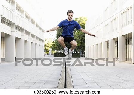 Young man jumping over divider View Large Photo Image Stock Photo - Young man jumping over divider. Fotosearch