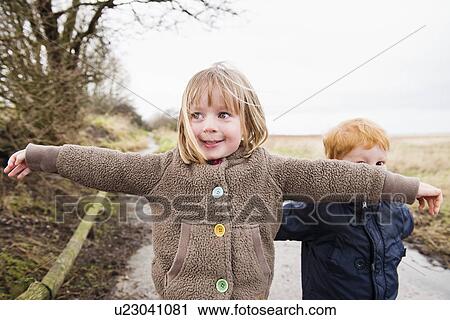 Young sister and brother playing on rural road View Large Photo Image Stock Image - Young sister and brother playing on rural road. Fotosearch