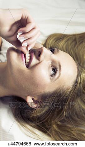 Young woman biting fingernail, close up View Large Photo Image Stock Photo - Young woman biting fingernail, close up. Fotosearch