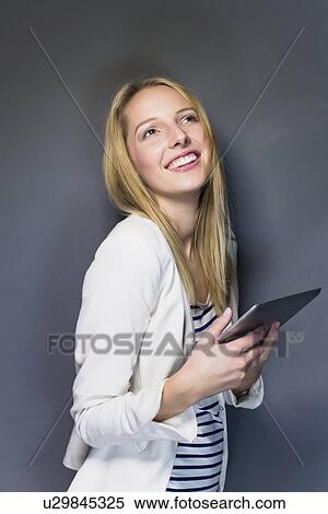 Young woman holding digital tablet View Large Photo Image Stock Photography - Young woman holding digital tablet. Fotosearch