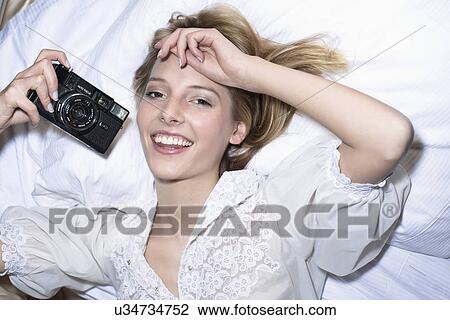 Young woman holding vintage camera View Large Photo Image Stock Image - Young woman holding vintage camera. Fotosearch