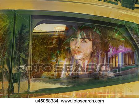 Picture - Young woman in back of taxi. Fotosearch
