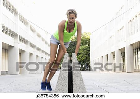 Young woman jumping over divider View Large Photo Image Stock Photograph - Young woman jumping over divider. Fotosearch