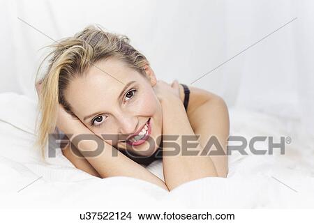 Picture - Young woman looking at camera, smiling. Fotosearch