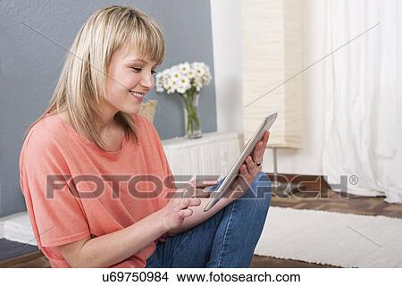 Young woman using digital tablet View Large Photo Image Picture - Young woman using digital tablet. Fotosearch