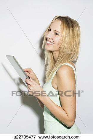 Young woman using digital tablet View Large Photo Image Stock Photo - Young woman using digital tablet. Fotosearch