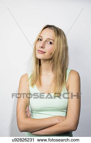 Young woman wearing green vest with arms folded View Large Photo Image Stock Image - Young woman wearing green vest with arms folded. Fotosearch