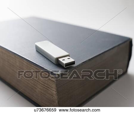 Flash drive and old book View Large Photo Image Stock Photo - Flash drive and old book. Fotosearch