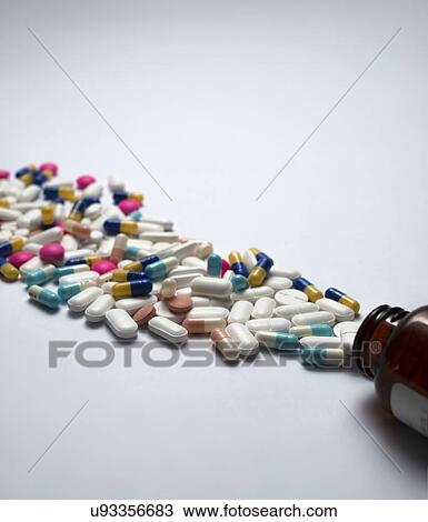 Pills spilling out of bottle View Large Photo Image Stock Image - Pills spilling out of bottle. Fotosearch
