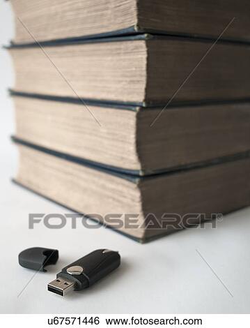 Stock Photograph - USB flash drive and old books. Fotosearch