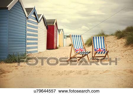 Beach huts and deck chairs, Southwold, Sussex, UK View Large Photo Image Stock Photo - Beach huts and deck chairs, Southwold, Sussex, UK. Fotosearch