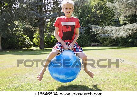 Boy jumping on space hopper View Large Photo Image Picture - Boy jumping on space hopper. Fotosearch