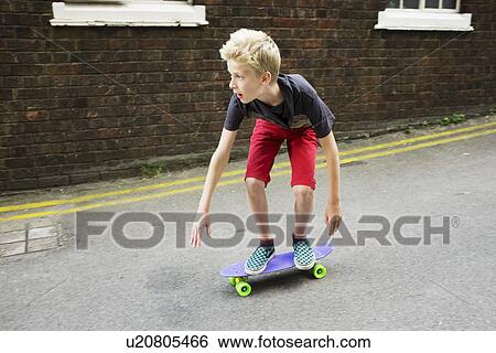 Stock Photograph - Boy skateboarding. Fotosearch