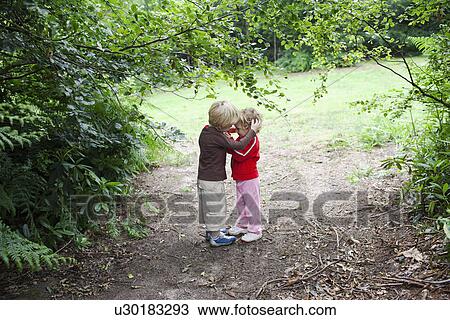 Stock Image - Brother and sister hugging. Fotosearch
