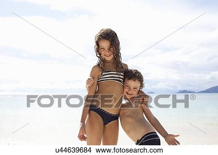 Brother and sister standing on beach in Seychelles View Large Photo Image Picture - Brother and sister standing on beach in Seychelles. Fotosearch