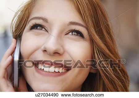 Close up of attractive young woman chatting on smartphone View Large Photo Image Stock Image - Close up of attractive young woman chatting on smartphone. Fotosearch