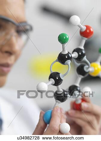 Stock Photo - Close up of scientist viewing a molecular structure in a laboratory. Fotosearch