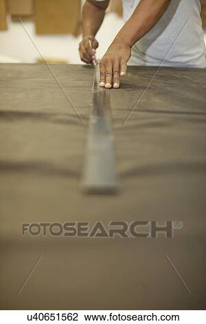 Close up of upholsterer marking leather skin with ruler and pencil View Large Photo Image Stock Image - Close up of upholsterer marking leather skin with ruler and pencil. Fotosearch