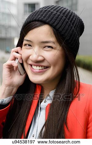 Stock Photo - Close up of woman using cellular phone. Fotosearch