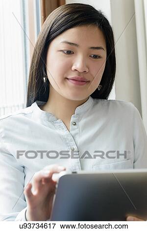 Close up of woman using digital tablet View Large Photo Image Stock Photo - Close up of woman using digital tablet. Fotosearch