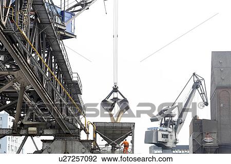 Crane grab transferring goods in port View Large Photo Image Stock Image - Crane grab transferring goods in port. Fotosearch